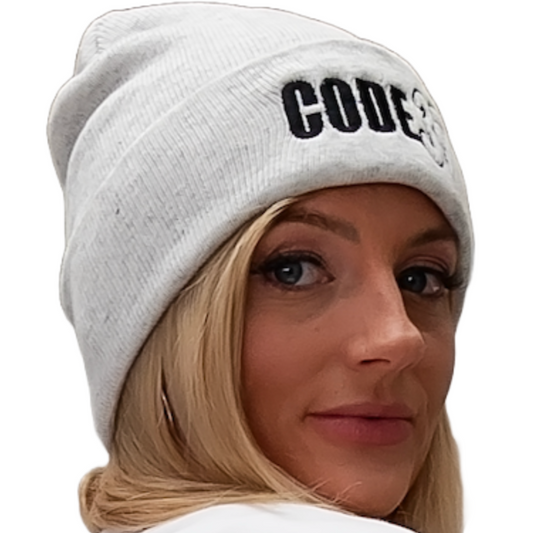 Person wearing a white beanie with 'CODE37' printed on it against a white background