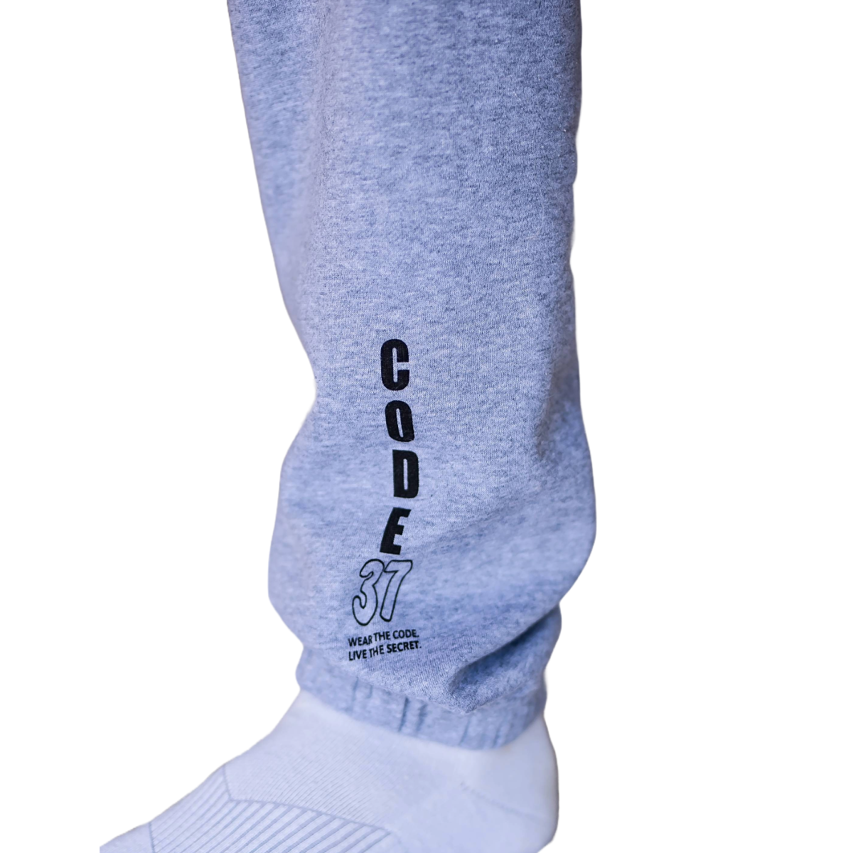 Grey sweatpants with a vertical black logo on a white background