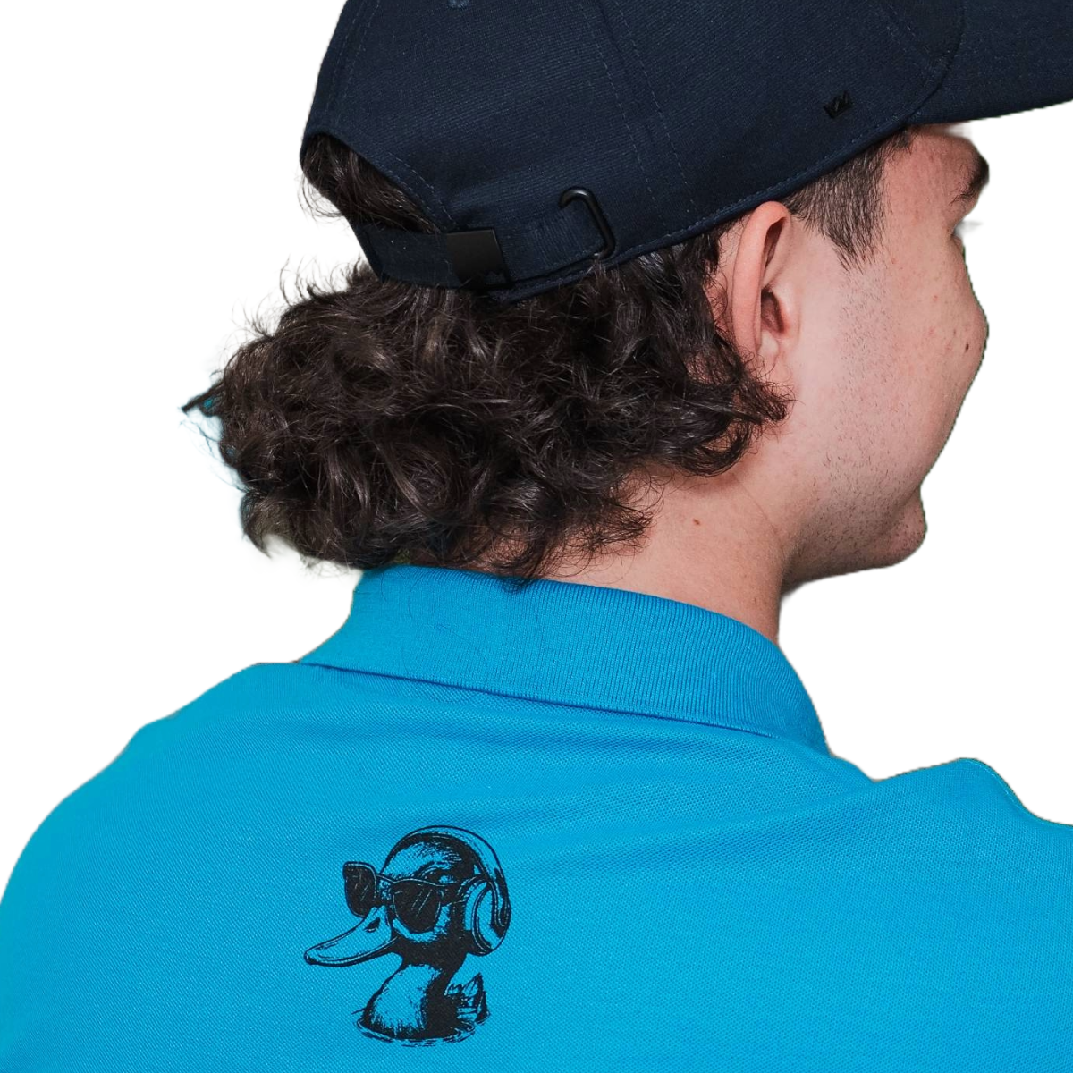 Person wearing a blue polo shirt with a logo on the back, facing away from the camera.